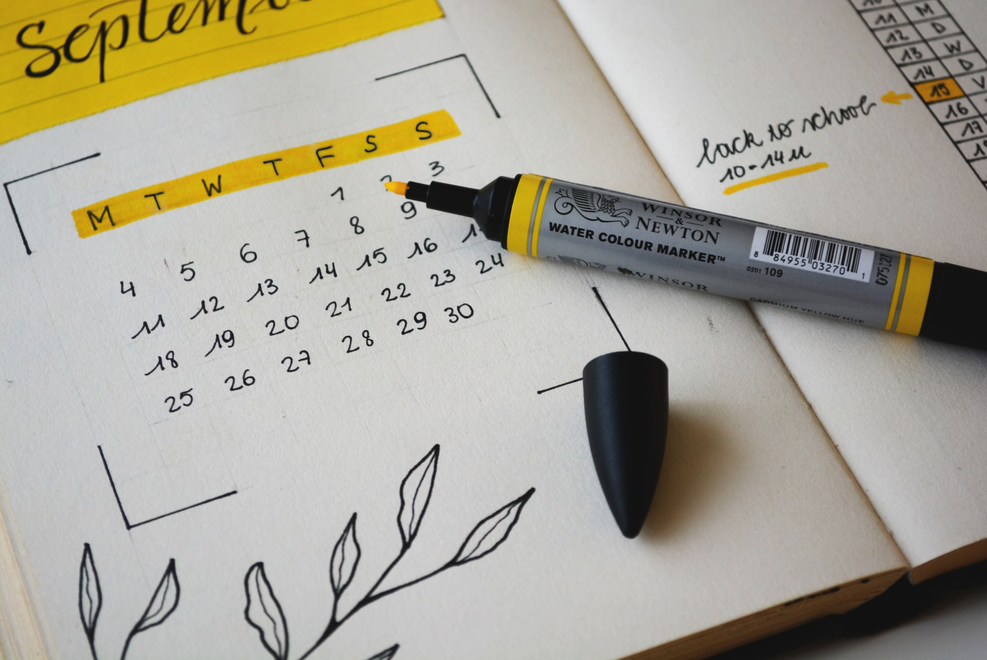 Calendar notebook showing September month highlighted in yellow