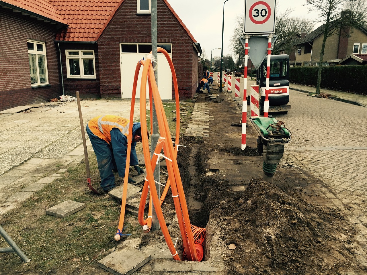 A worker installs fibre optic cables
