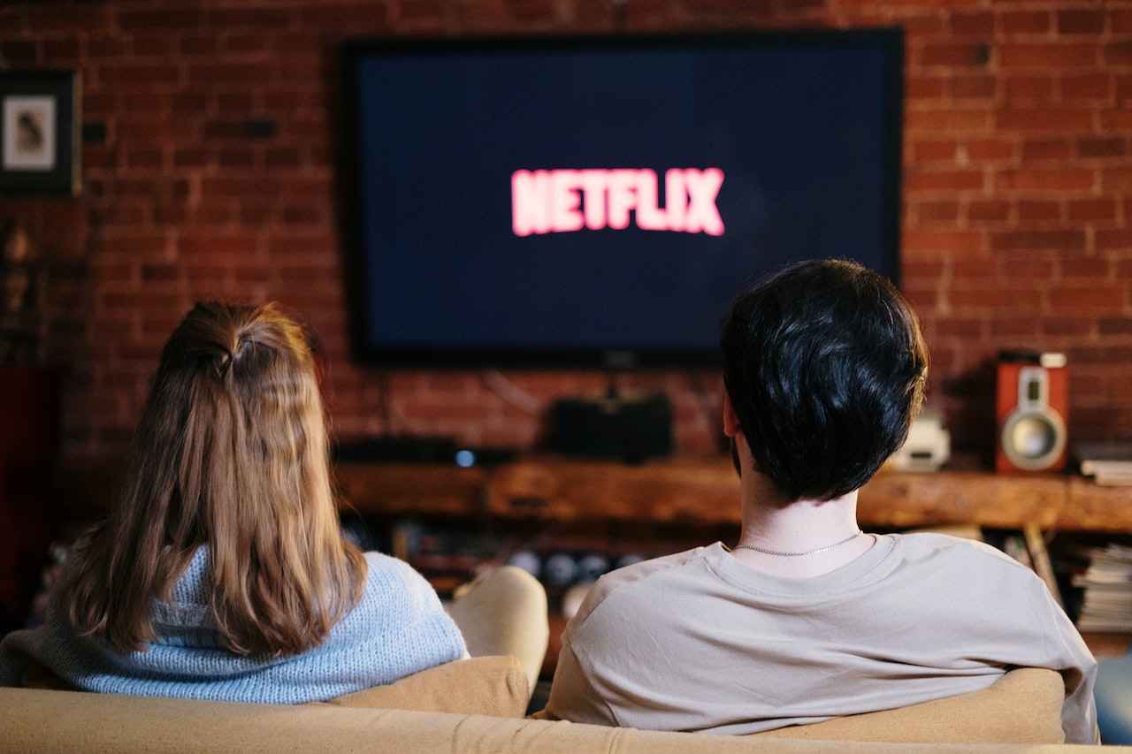 A couple watching Netflix on their TV