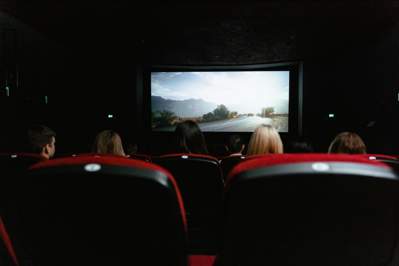 A row of seats in front of a cinema screen