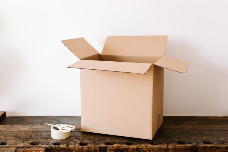 A moving box, scissors and a roll of tape. Being well-supplied is one of the best ways to beat moving house stress. 