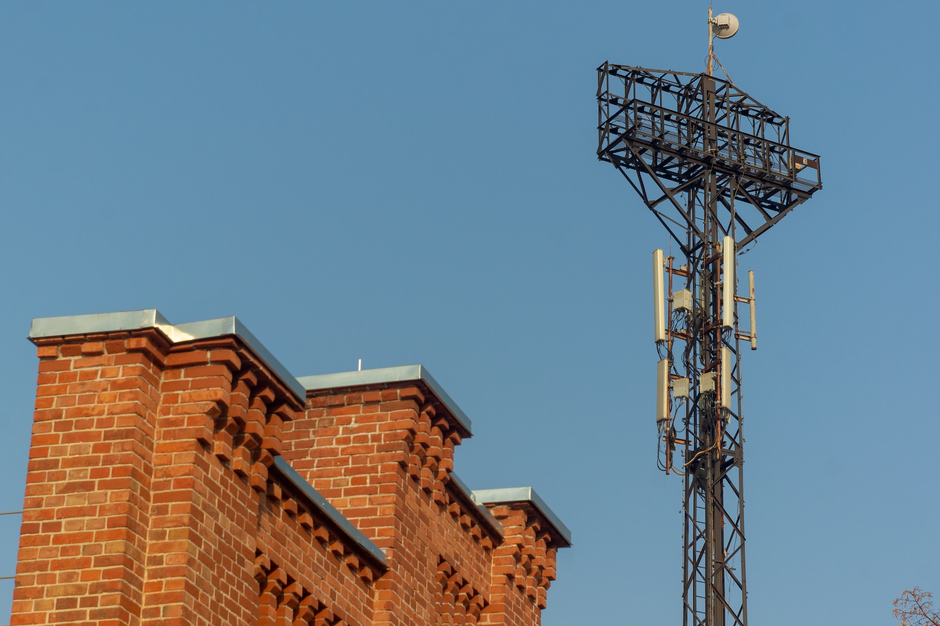 A mobile tower next to a brick building