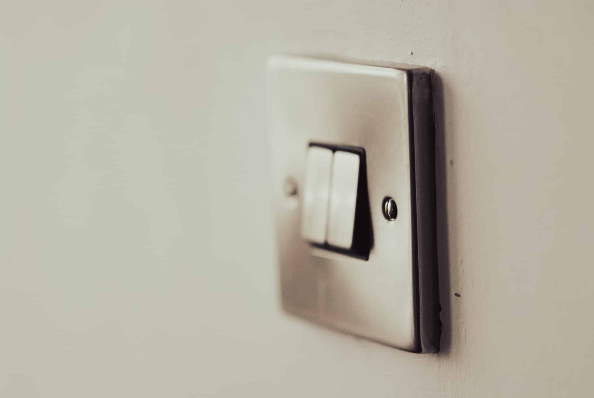 A light switch on a white wall