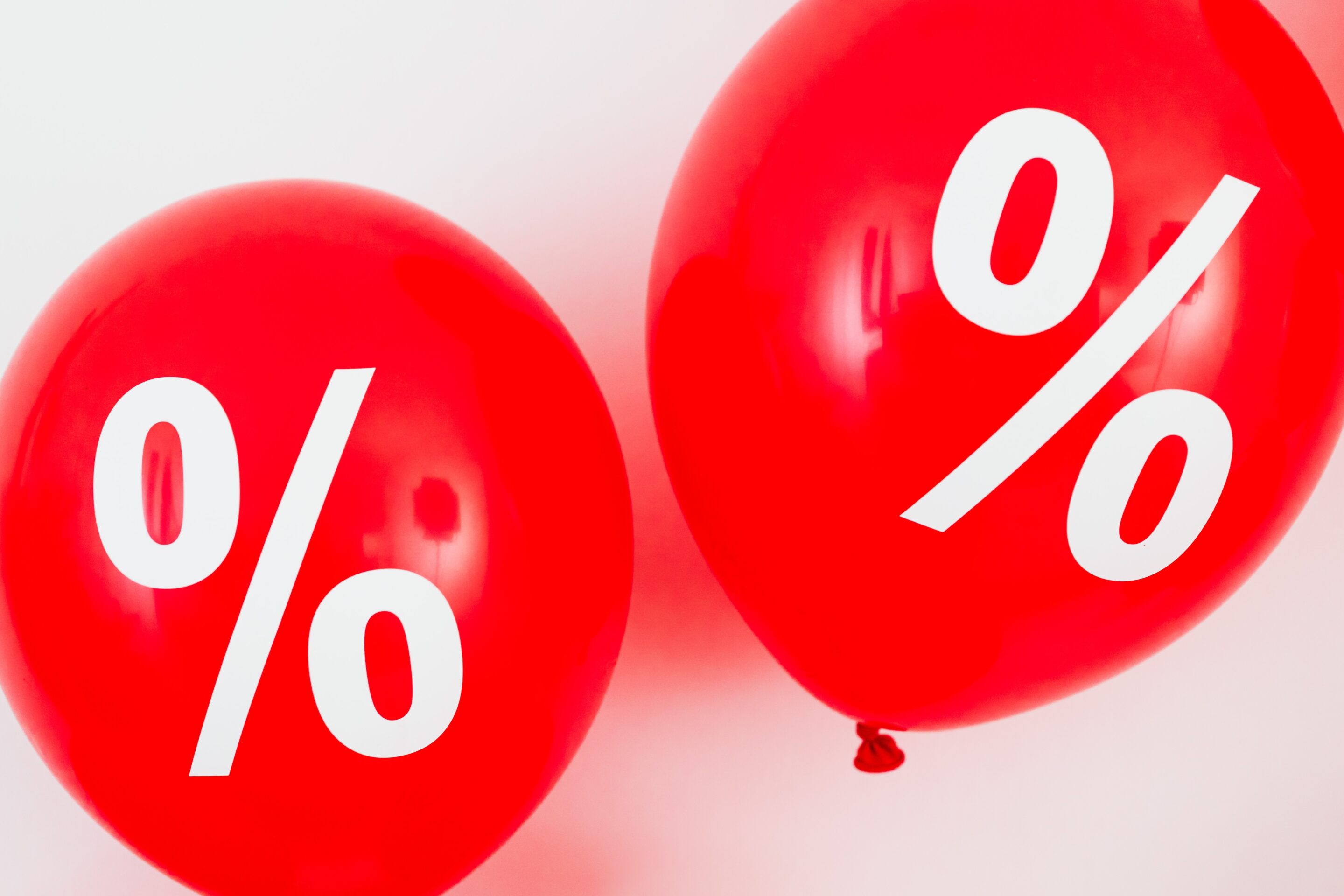 Two red balloons with percent signs painted on them - save up to 50% with Black Friday broadband promotions
